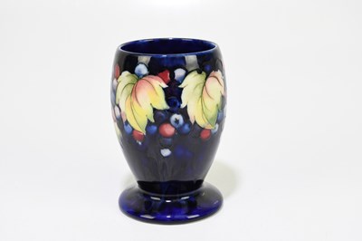 Lot 24 - MOORCROFT; a 'Leaf and Berry' pattern vase,...