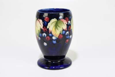 Lot 24 - MOORCROFT; a 'Leaf and Berry' pattern vase,...