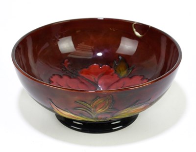 Lot 47 - MOORCROFT; a 'Hibiscus' pattern flambe bowl,...