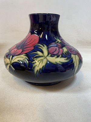 Lot 249 - MOORCROFT; a squat form vase in the 'Anemone'...