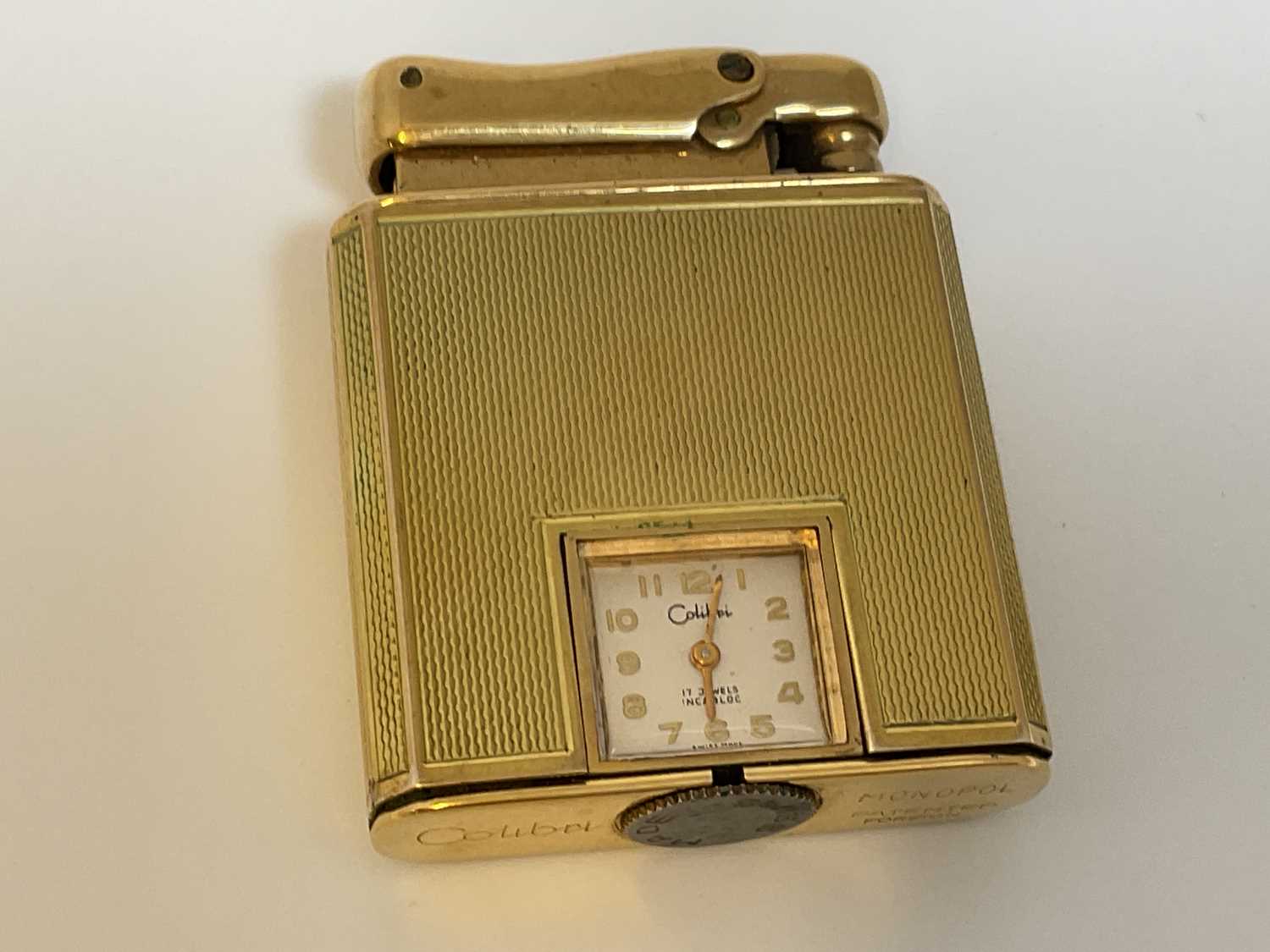 Lot 584 - COLIBRI; a 9ct gold cased 'Monopol' lighter