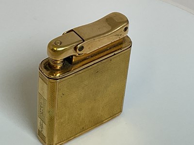 Lot 584 - COLIBRI; a 9ct gold cased 'Monopol' lighter...