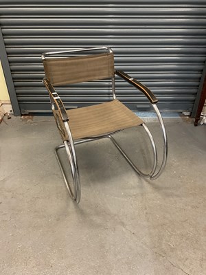 Lot 62 - A tubular chrome framed elbow chair with...