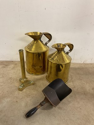 Lot 201 - A pair of graduated brass jugs, 300ozs and...