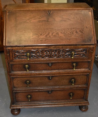 Lot 97 - An oak bureau, the fall front above four long...