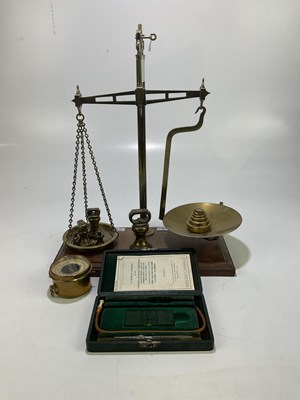 Lot 2182 - A late 19th century set of brass balance scale...