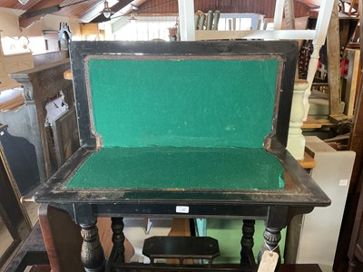 Lot 22 - A Victorian ebonised fold over games table...