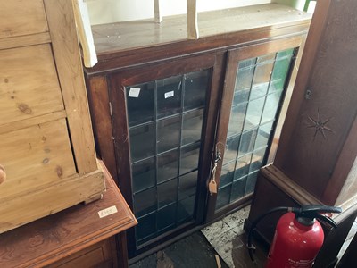 Lot 40 - An oak bookcase with two leaded glazed doors,...
