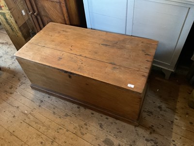 Lot 95 - An old pine blanket chest with iron handles on...