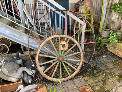 Lot 103 - BLACKSTONE; a large cast iron cart wheel, with...