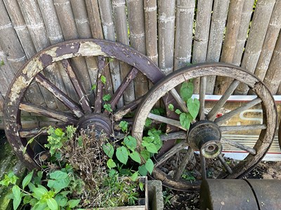 Lot 103 - BLACKSTONE; a large cast iron cart wheel, with...