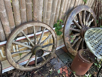 Lot 103 - BLACKSTONE; a large cast iron cart wheel, with...