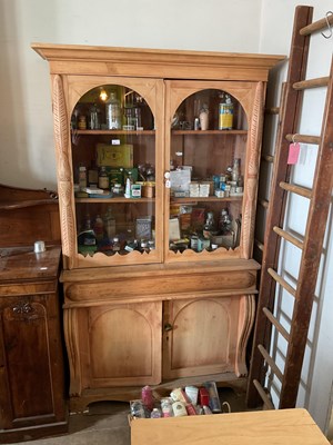 Lot 186 - A pine bookcase with moulded cornice above...