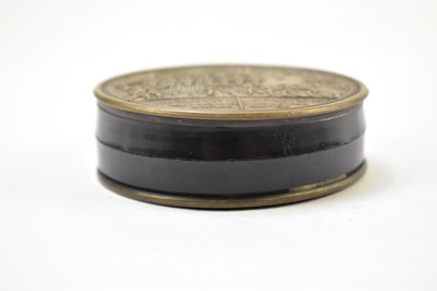 Lot 2 - A 19th century French metal and lacquered snuff box of circular form