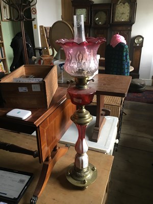 Lot 197 - A Victorian Bohemian oil lamp with cranberry...