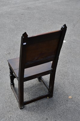 Lot 1666 - An 18th century carved oak hall chair, 95cm.