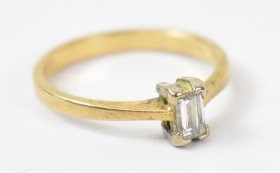 Lot 859 - An 18ct yellow gold emerald cut diamond ring,...
