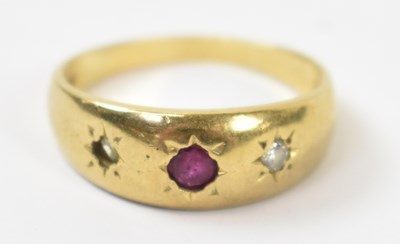Lot 854 - An 18ct yellow gold ring with central red...