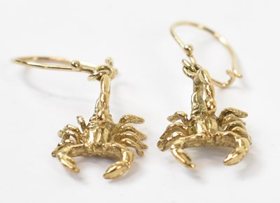 Lot 898 - A pair of yellow metal earrings modelled as...