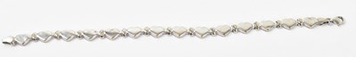 Lot 884 - A 9ct white gold love heart bracelet, length...