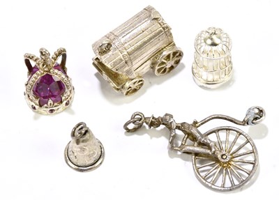 Lot 1463 - A group of five white metal charms, to include...