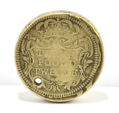 Lot 1506 - A £3 12 shilling brass coin weight.