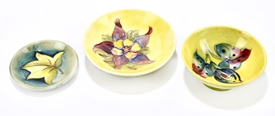 Lot 31 - WALTER MOORCROFT; two footed bowls, to include...