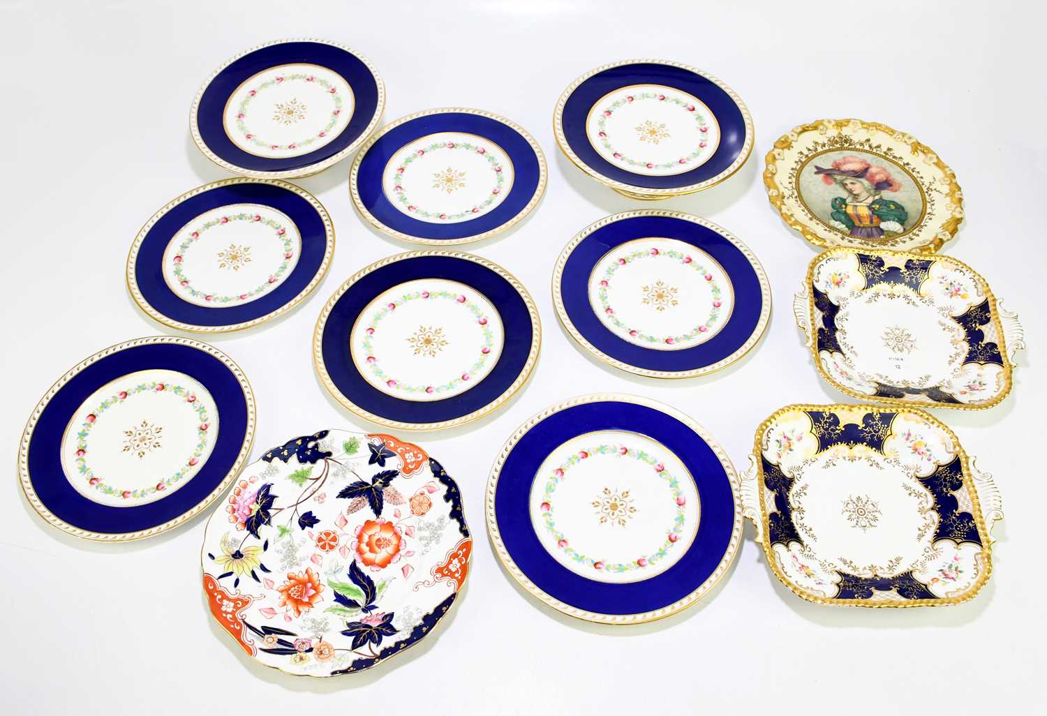 Lot 742 - COALPORT; two twin handled square plates in...