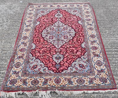 Lot 185 - A large Persian red ground carpet, 207 x 52cm.