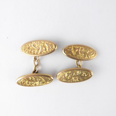 Lot 1284 - A pair of 9ct gold oval floral patterned...