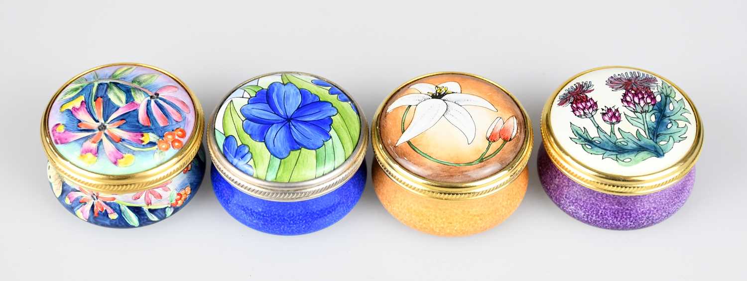 Lot 107 - MOORCROFT; four enamel pill boxes and covers...