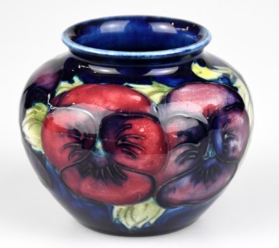 Lot 30 - WALTER MOORCROFT; a squat vase in the 'Pansy'...