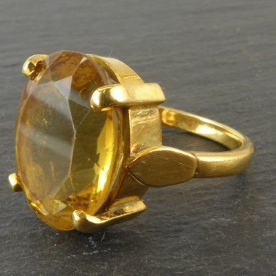 Lot 1139 - A yellow metal claw set citrine dress ring,...