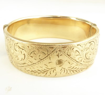 Lot 1185 - A wide bodied hinged bracelet with floral...