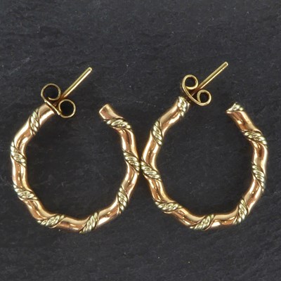Lot 1274 - A pair of 9ct gold bi-colour twist hoop...