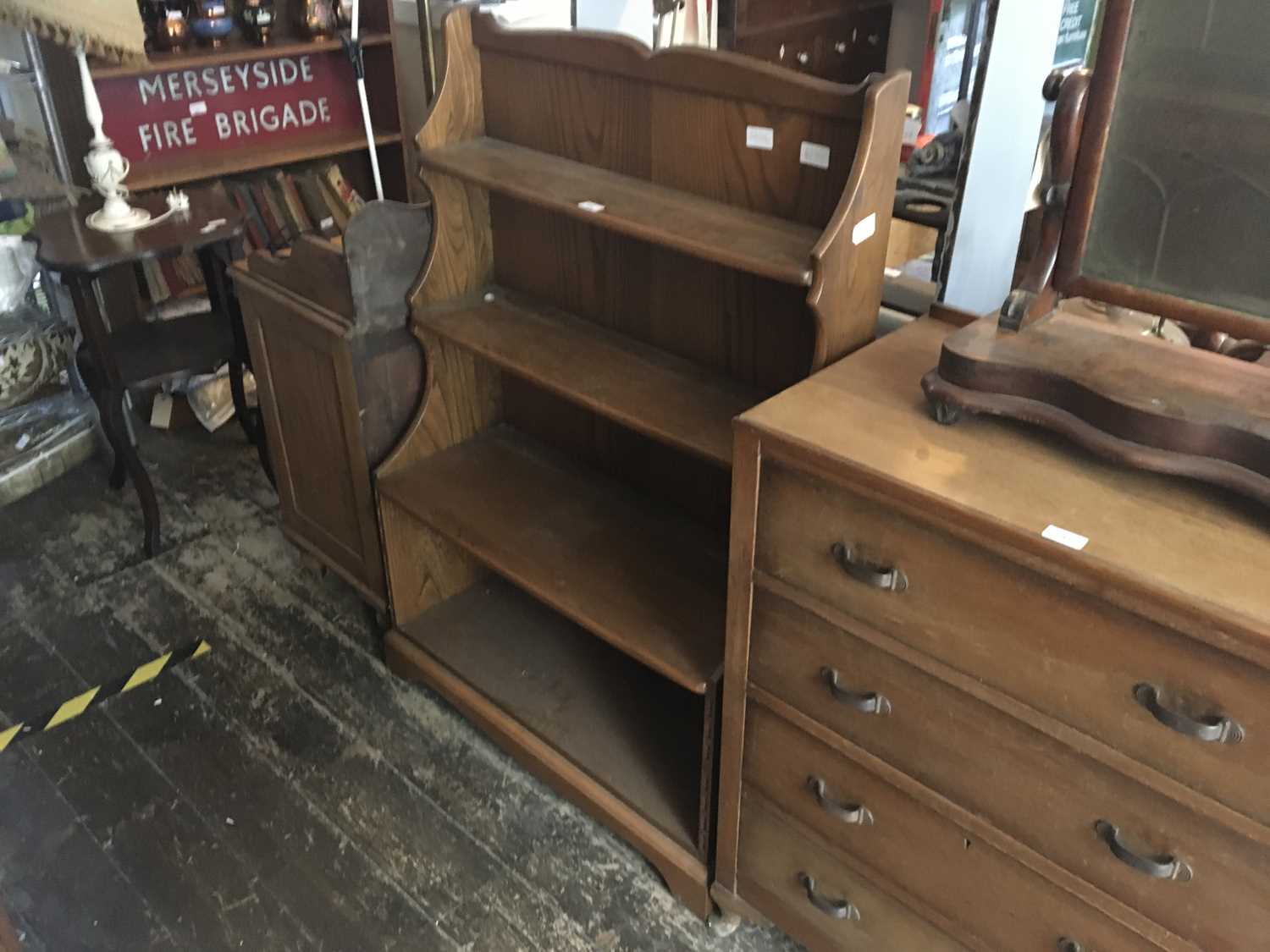 Lot 294 ERCOL; a medium elm waterfall bookcase,