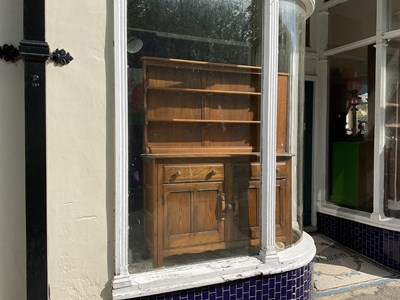 Lot 326 - ERCOL; a medium elm dresser with plate rack...