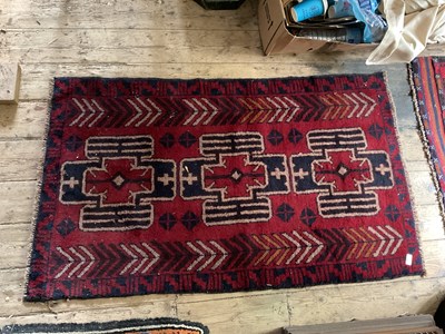 Lot 340 - An Eastern rug with stylised decoration on a...