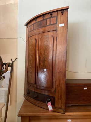 Lot 377 - A Georgian mahogany bowfront corner cupboard...