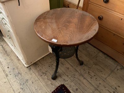 Lot 380 - A cast iron pub table with later wooden top,...