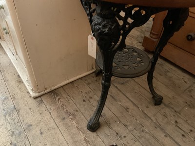 Lot 380 - A cast iron pub table with later wooden top,...