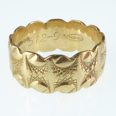 Lot 1102 - A 9ct gold patterned band ring, size P, approx....