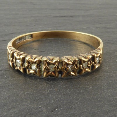 Lot 1101 - A 9ct gold half eternity ring with seven tiny...