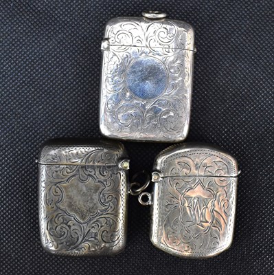 Lot 868 - Three hallmarked silver floral decorated vesta...