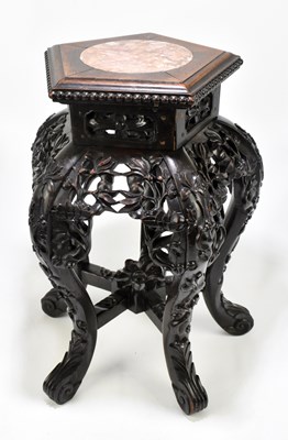 Lot 651 - A Chinese carved rosewood jardinière stand