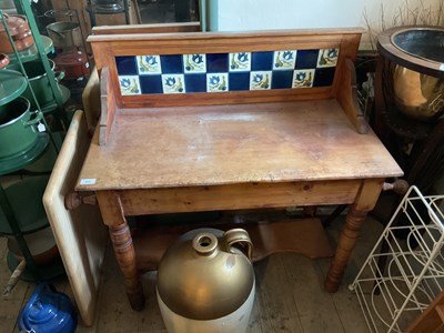 Lot 425 - An old pine wash stand with tiled back and...