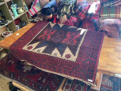 Lot 452 - A Beluchi Afghan rug with stylised decoration...