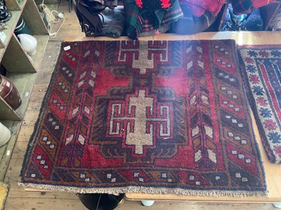 Lot 453 - An Afghan rug with stylised decoration on a...