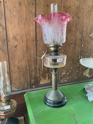 Lot 477 - A late Victorian oil lamp with cranberry and...