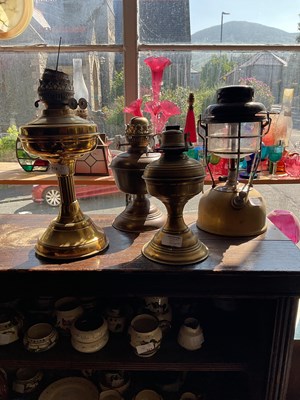 Lot 518 - Three brass oil lamps together with a further...